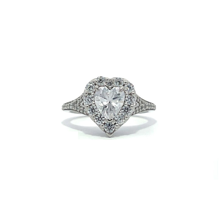 Silver heart-shaped diamond engagement ring with a halo setting and split shank on a white background.