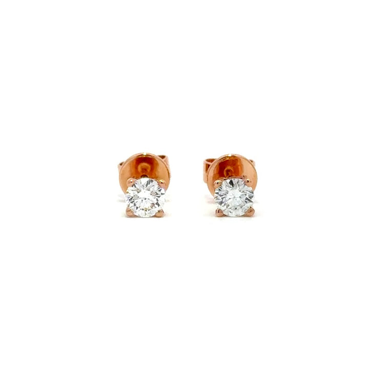 Rose gold stud earrings with a single diamond in each setting, on a white background.
