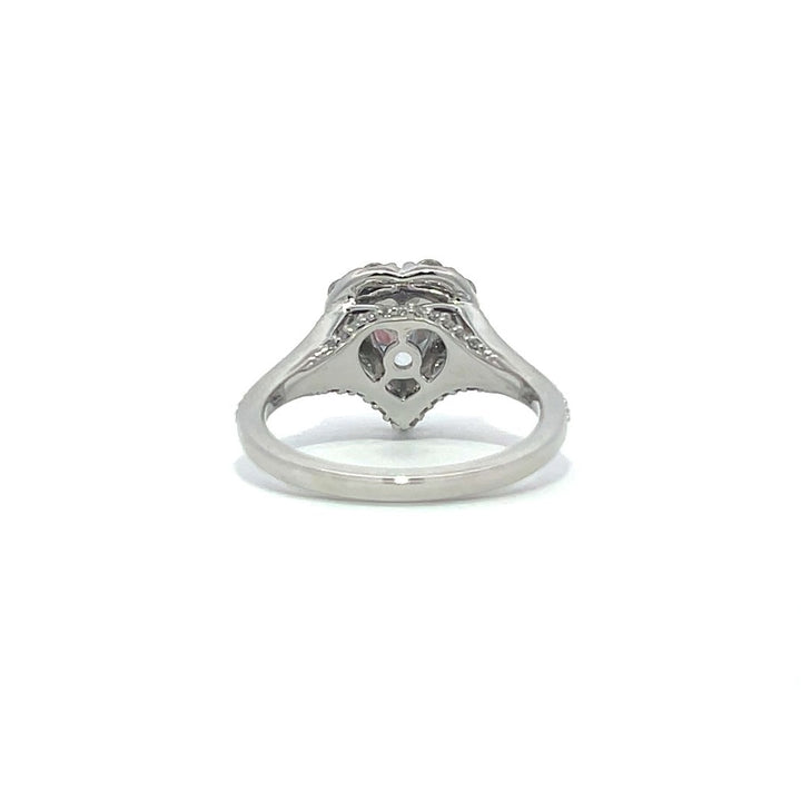 Silver heart-shaped diamond engagement ring with a halo setting and split shank on a white background.