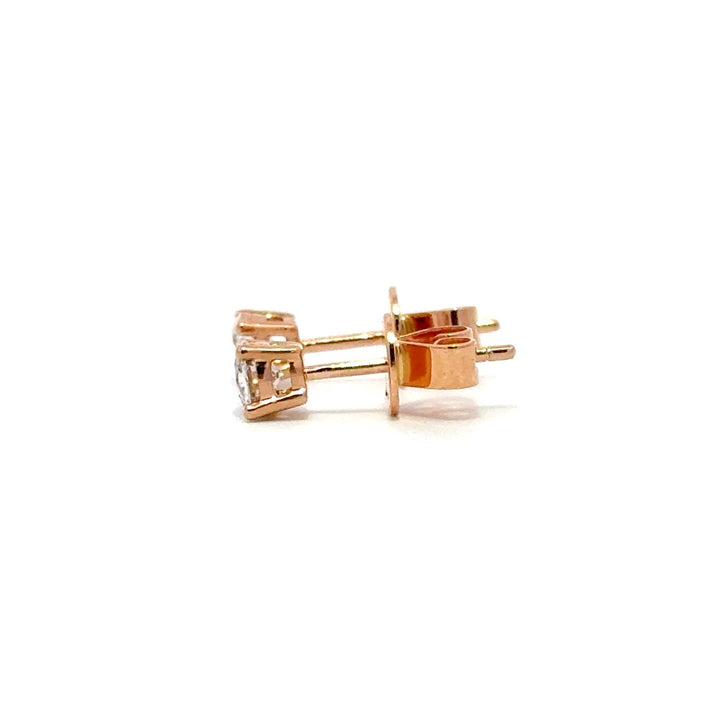 Rose gold stud earrings with a single diamond in each setting, on a white background.