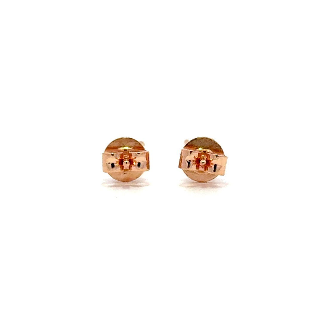 Rose gold stud earrings with a single diamond in each setting, on a white background.