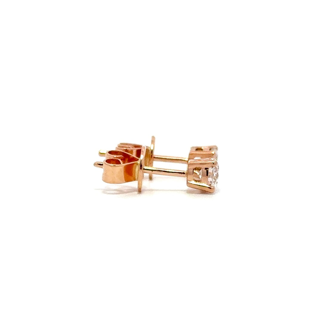 Rose gold stud earrings with a single diamond in each setting, on a white background.