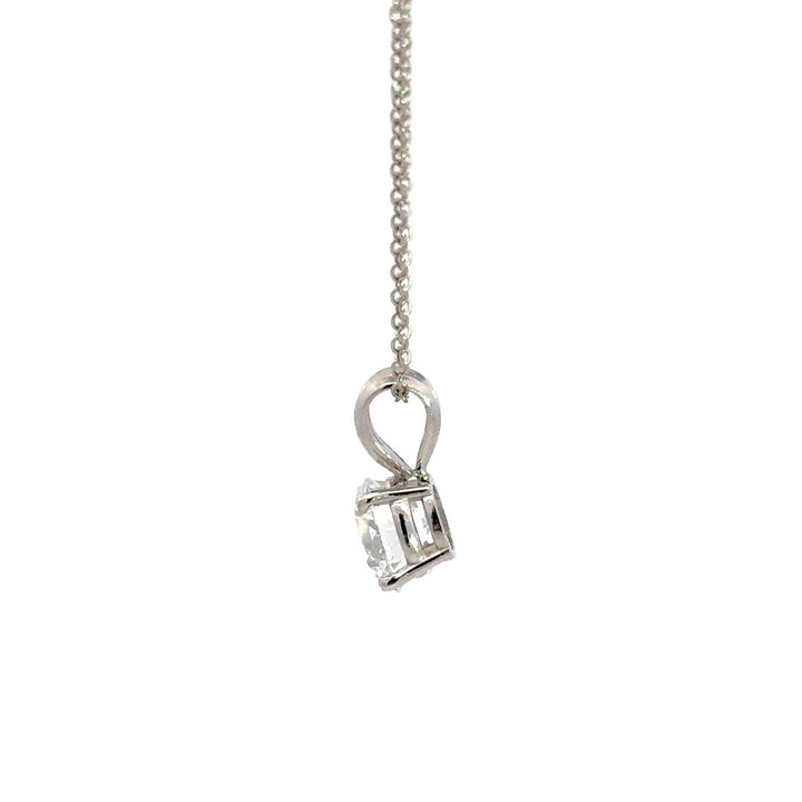 Silver necklace with round cut diamond pendant on a white background