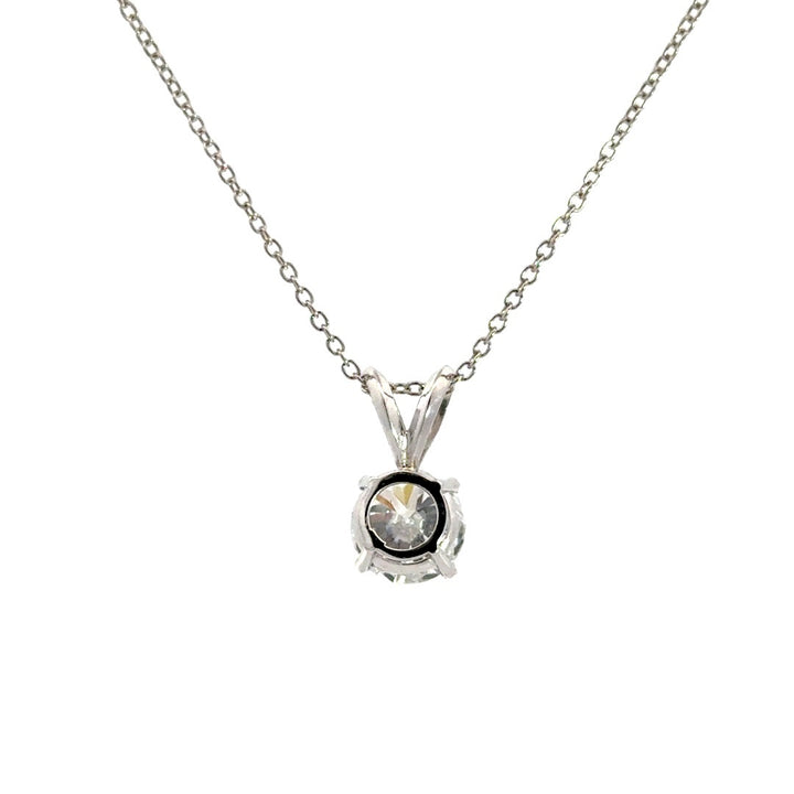 Silver necklace with round cut diamond pendant on a white background