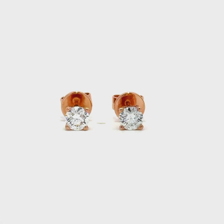 Rose gold stud earrings with a single diamond in each setting, on a white background.