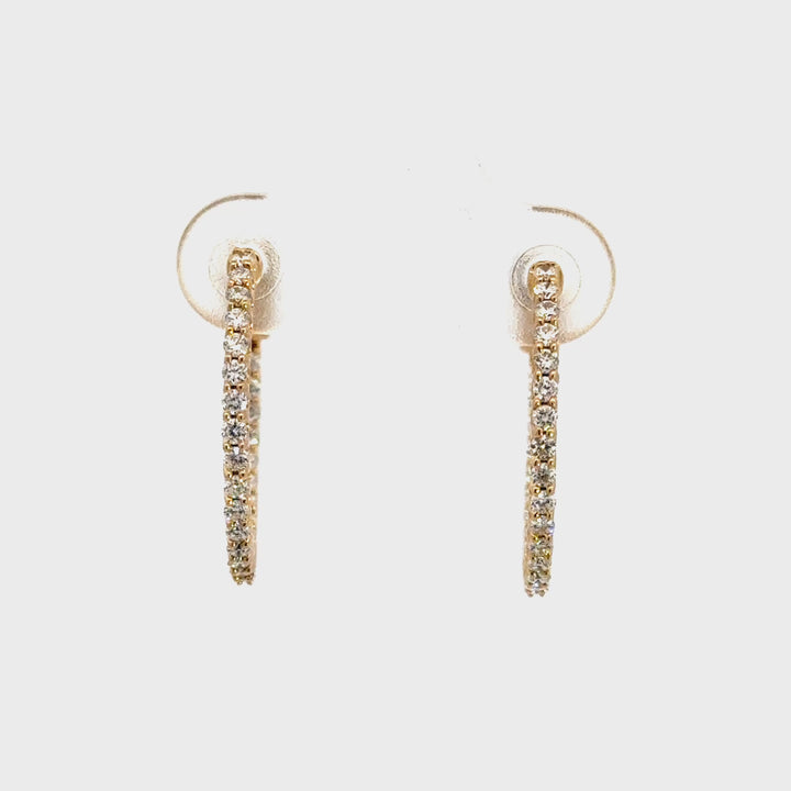 Pair of gold diamond hoop earrings against white background