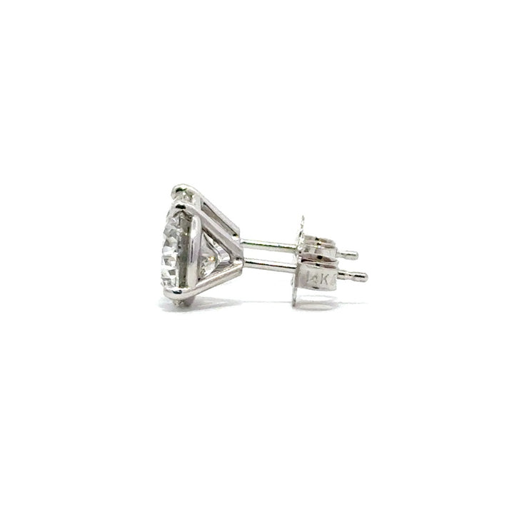 Side view of silver stud earrings in a white background