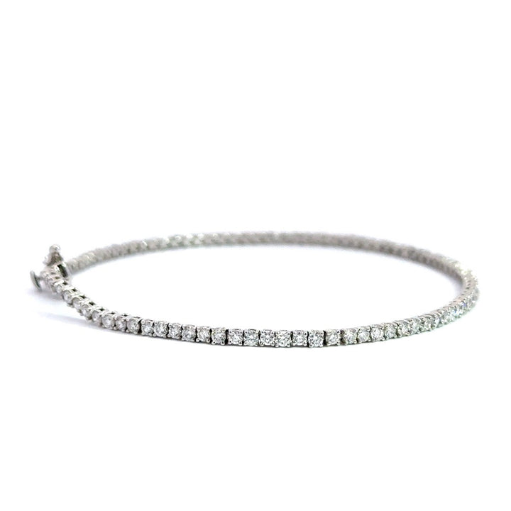 Silver diamond tennis bracelet on a white background.