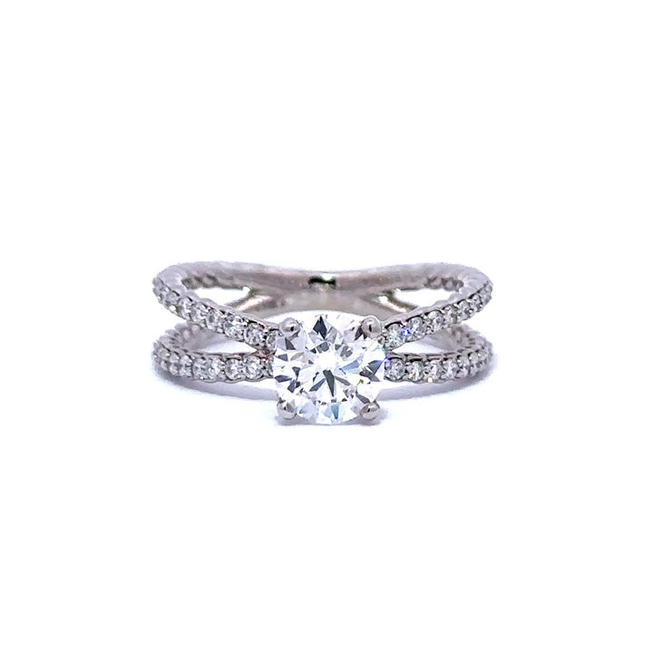 Silver engagement  ring with a round-cut diamond center stone and two split diamond bands, on a white background.