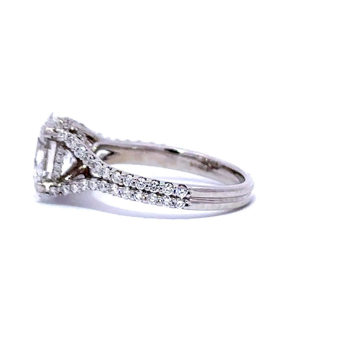 Silver engagement ring with an oval-cut diamond center stone and split diamond bands, on a white background.