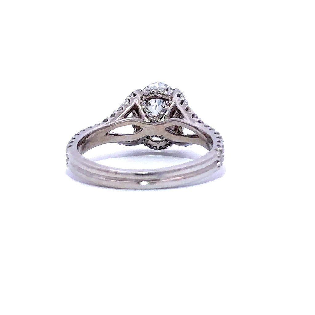 Silver engagement ring with an oval-cut diamond center stone and split diamond bands, on a white background.