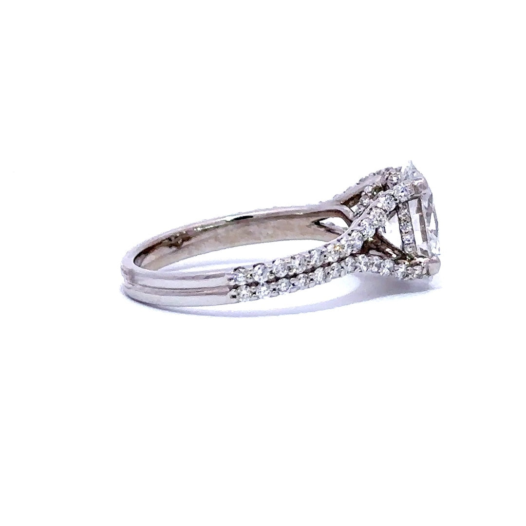 Silver engagement ring with an oval-cut diamond center stone and split diamond bands, on a white background.