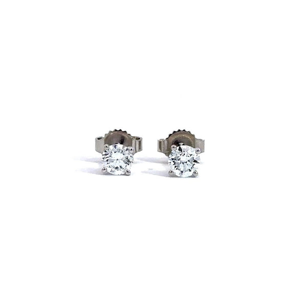 Pair of white gold stud earrings with a triangular setting of diamonds on a white background.