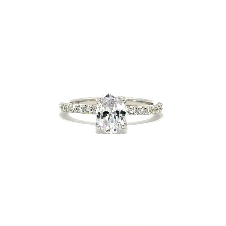 Front view of a silver engagement ring with a round-cut center diamond.