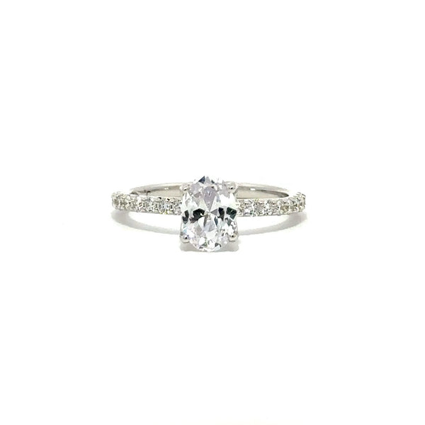 Front view of a silver engagement ring with a round-cut center diamond.