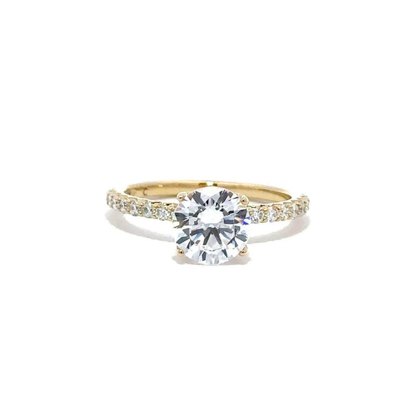 Front view of gold engagement ring with a round-cut center diamond and  tiny diamond in the band