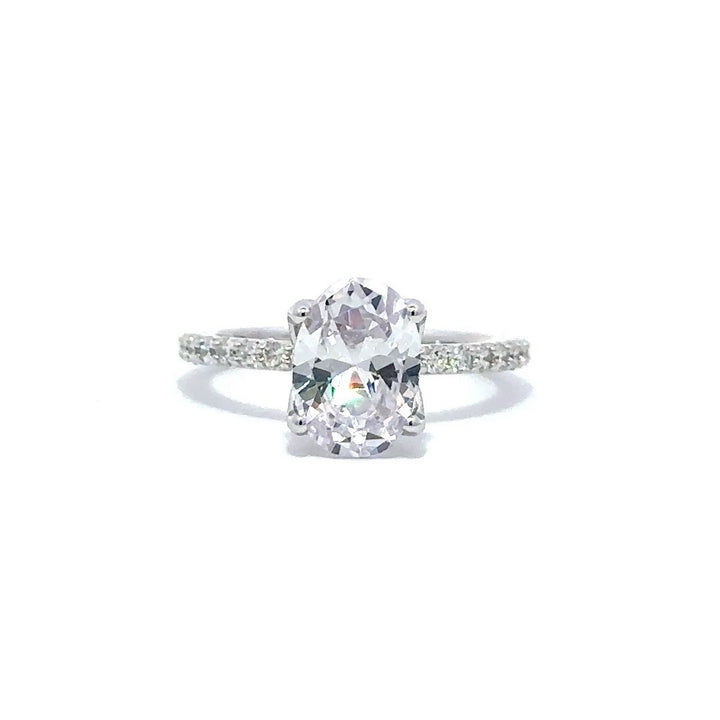 Front view of a silver engagement ring with a round-cut center diamond.