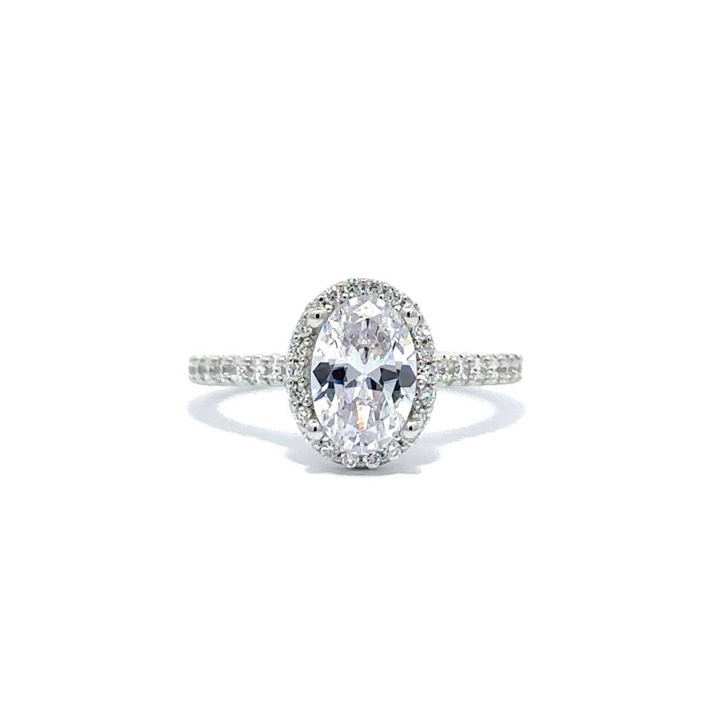 Front view of a silver engagement ring with a round-cut center diamond.