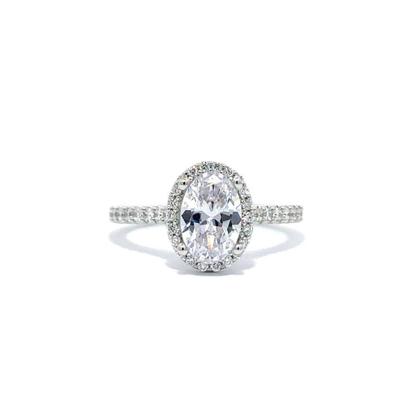 Front view of a silver engagement ring with a round-cut center diamond.