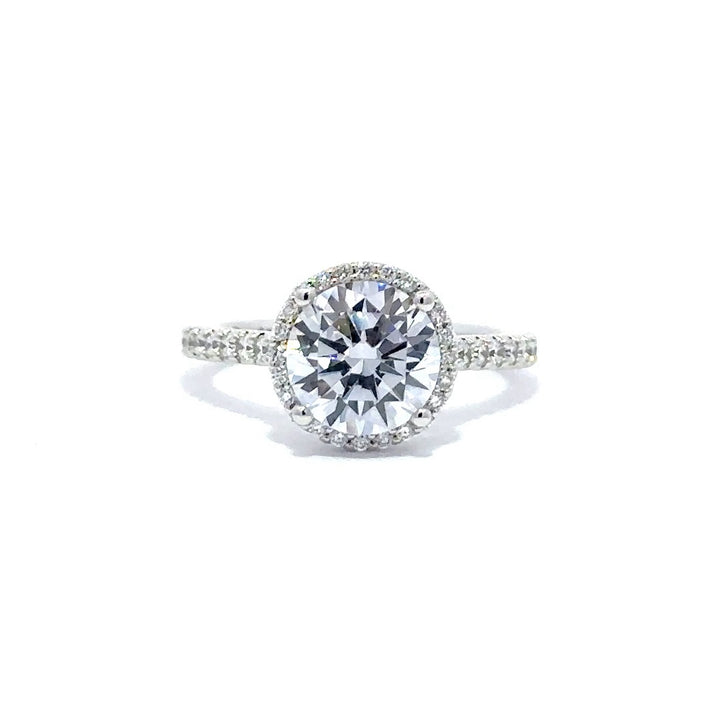 Silver engagement ring with a round-cut center diamond.