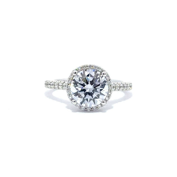 Silver engagement ring with a round-cut center diamond.