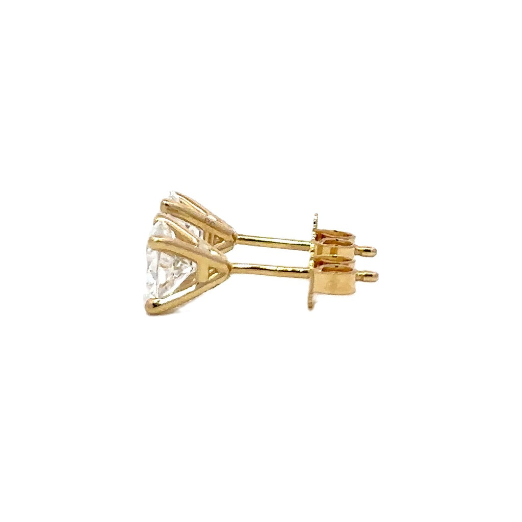 Pair of yellow gold stud earrings with a triangular setting of diamonds on a white background.