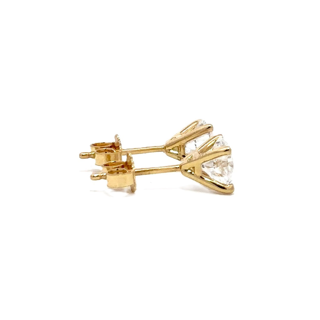 Pair of yellow gold stud earrings with a triangular setting of diamonds on a white background.