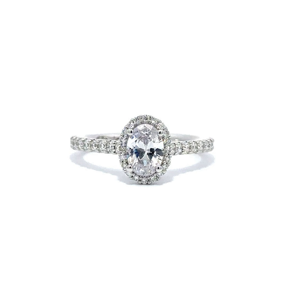 Front view of a silver engagement ring with a round-cut center diamond.