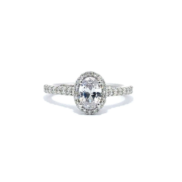 Front view of a silver engagement ring with a round-cut center diamond.