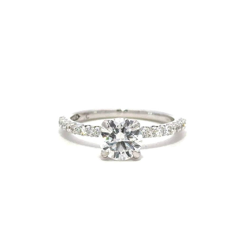 Front view of a silver engagement ring with a round-cut center diamond.