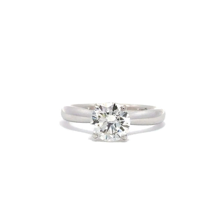 Front view of silver engagement ring with a round-cut center diamond.