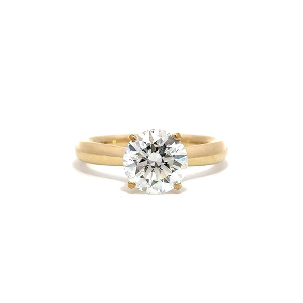 Gold engagement ring with a round-cut center diamond.