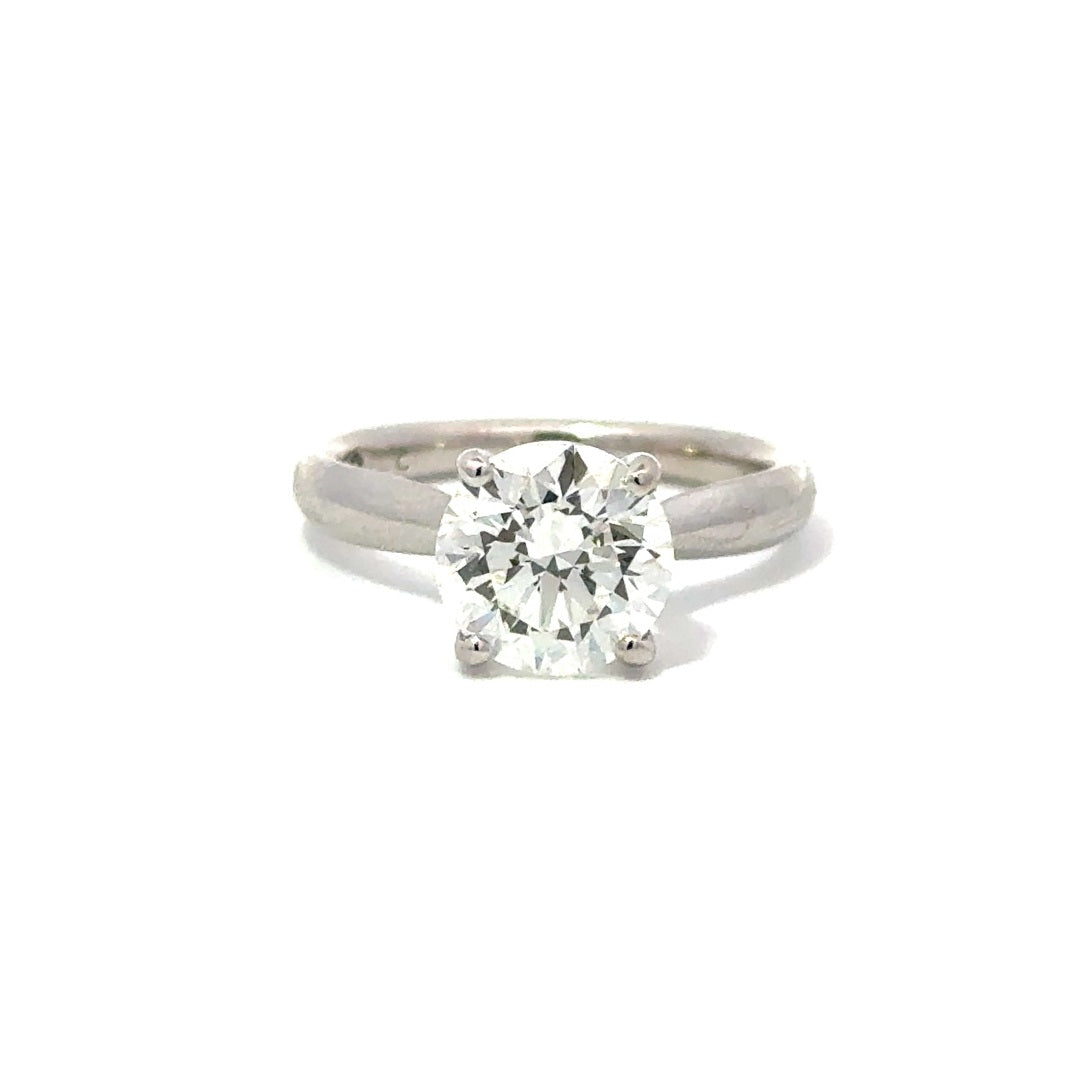 Front view of silver engagement ring with a round-cut center diamond.