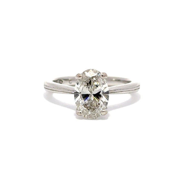 Silver engagement ring with a oval-cut center diamond.