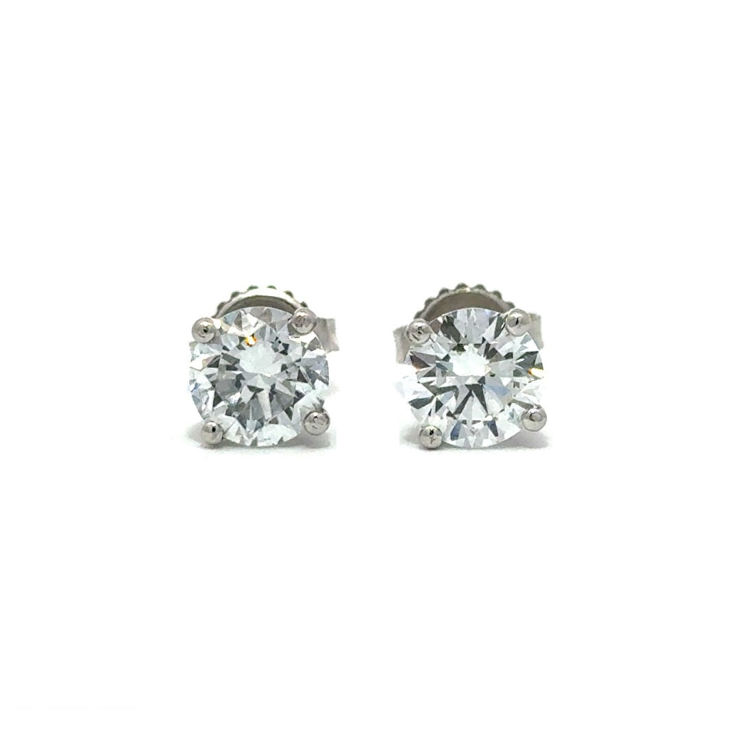 Pair of silver stud diamond earrings on a white background