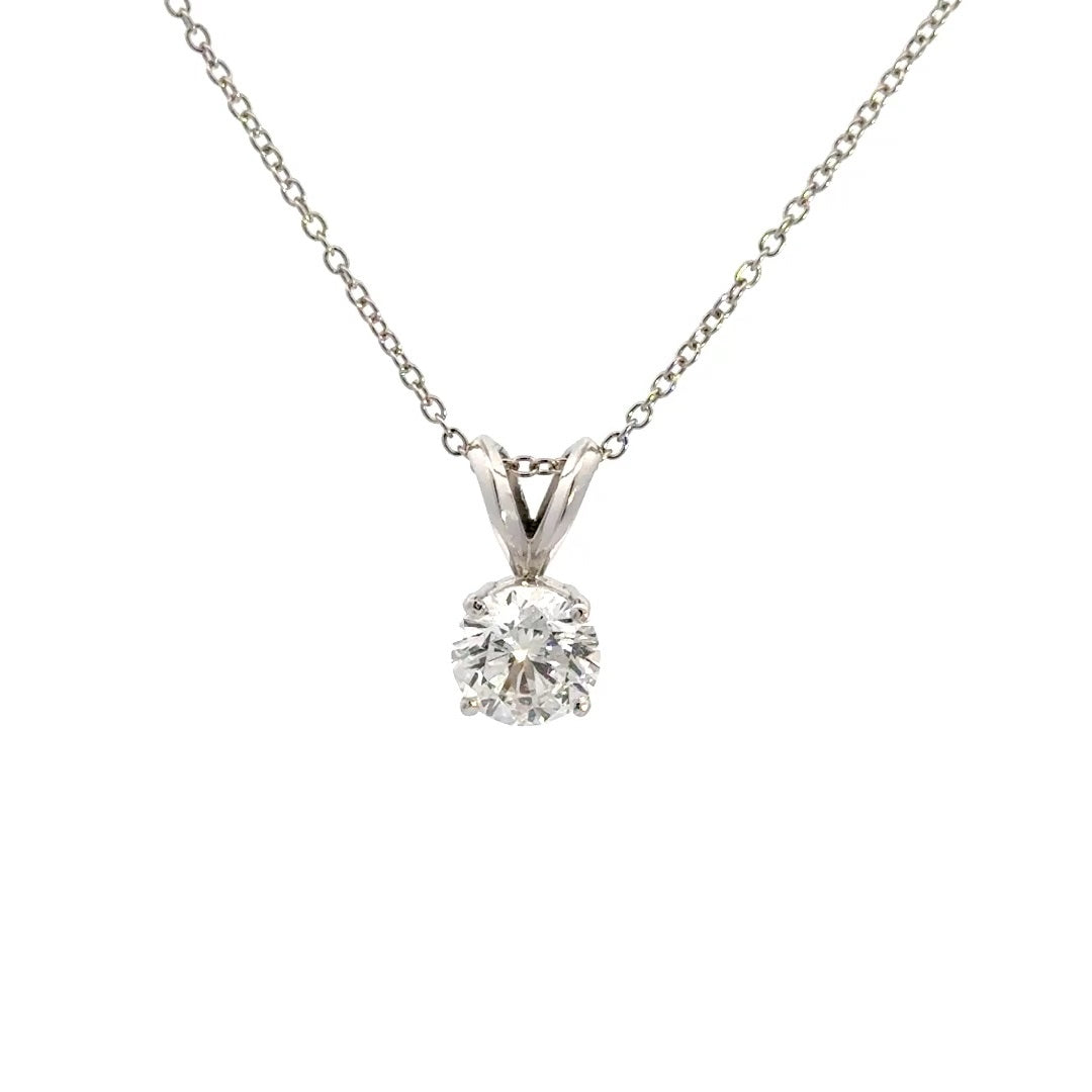 Silver necklace with round cut diamond pendant on a white background