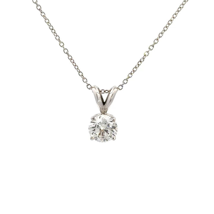 Silver necklace with round cut diamond pendant on a white background