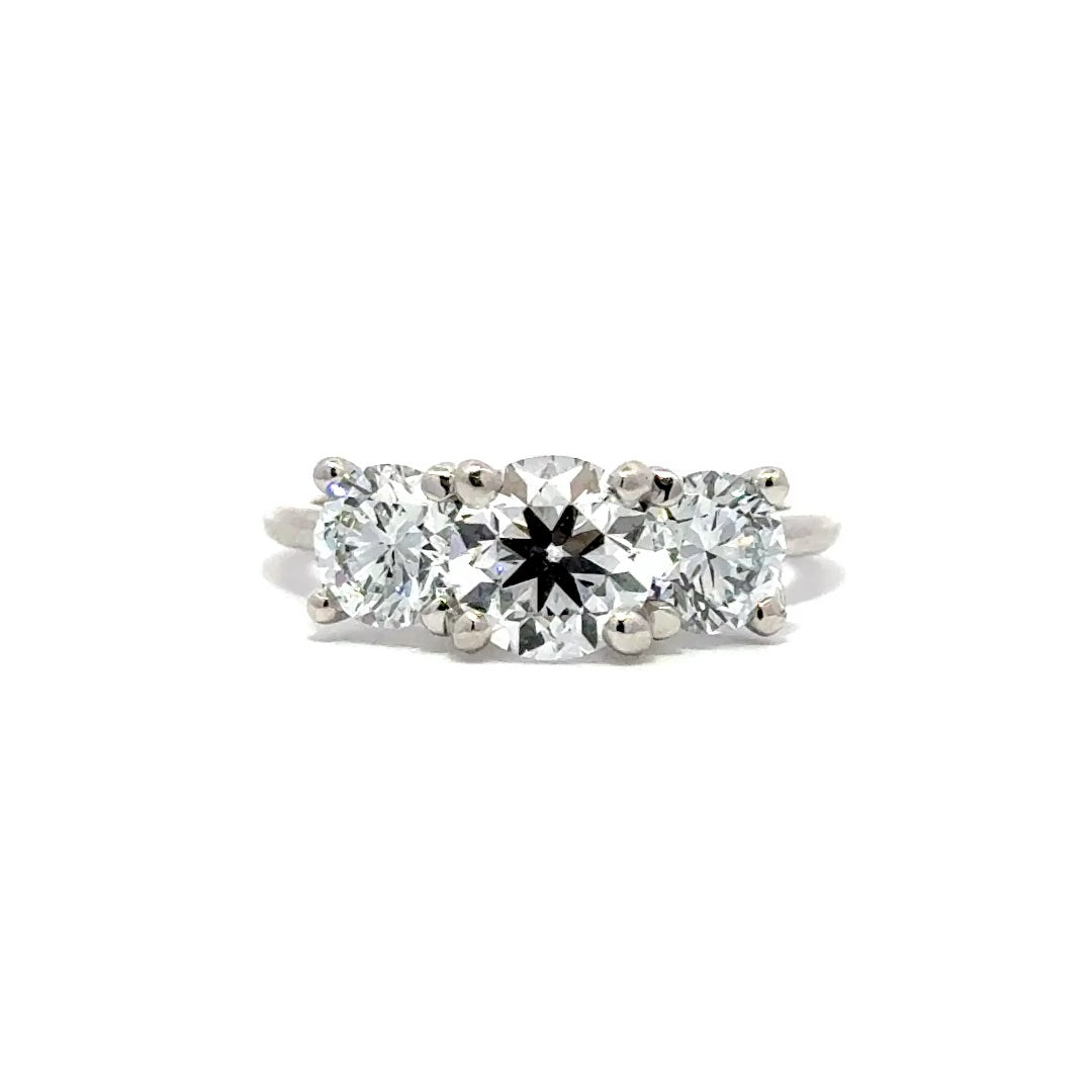 Silver three stone diamond ring in a white background