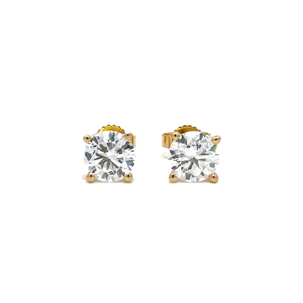 Pair of yellow gold stud earrings with a triangular setting of diamonds on a white background.