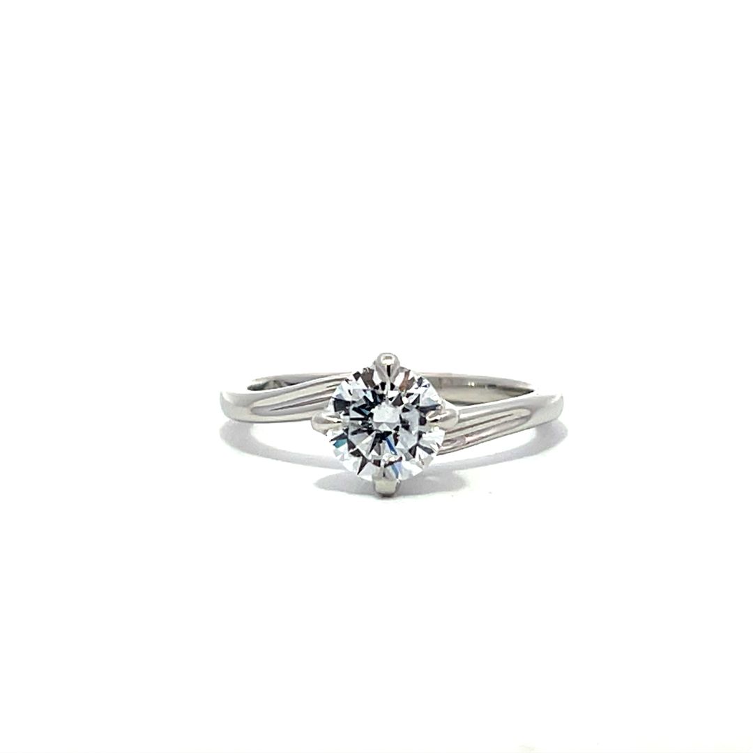 White gold round diamond solitaire engagement ring on a white background.