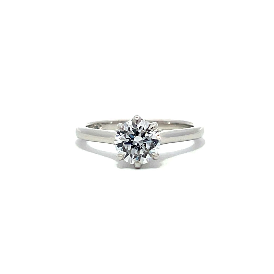 White gold round diamond solitaire engagement ring on a white background.