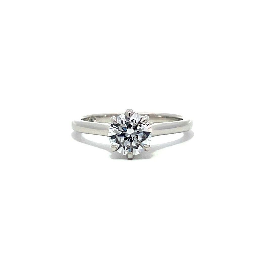 White gold round diamond solitaire engagement ring on a white background.