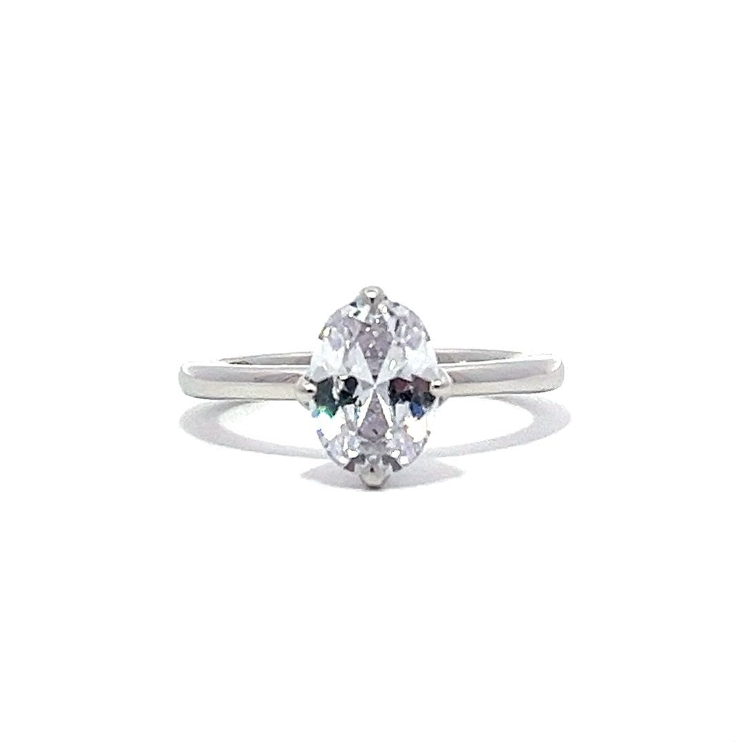 White gold oval diamond solitaire engagement ring on a white background.