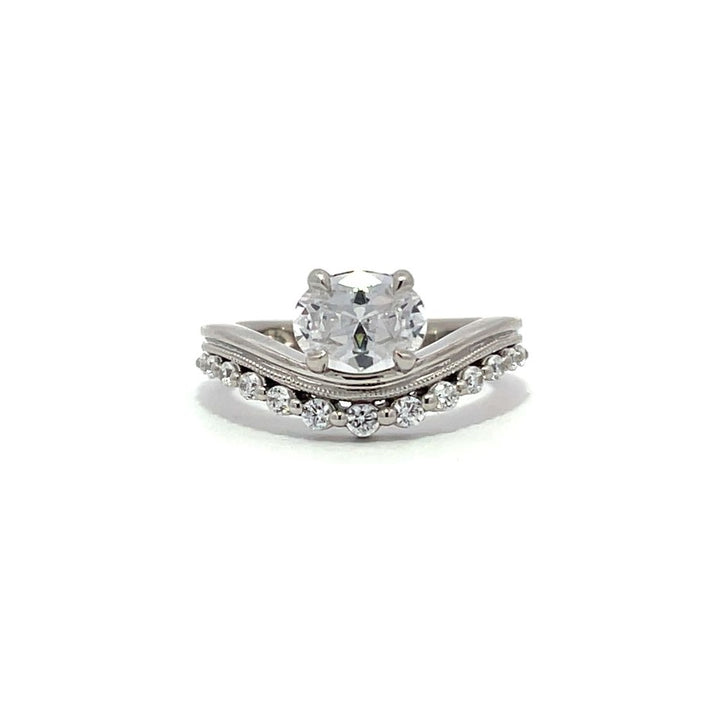 White gold diamond engagement ring set with a matching wedding band on a white background.