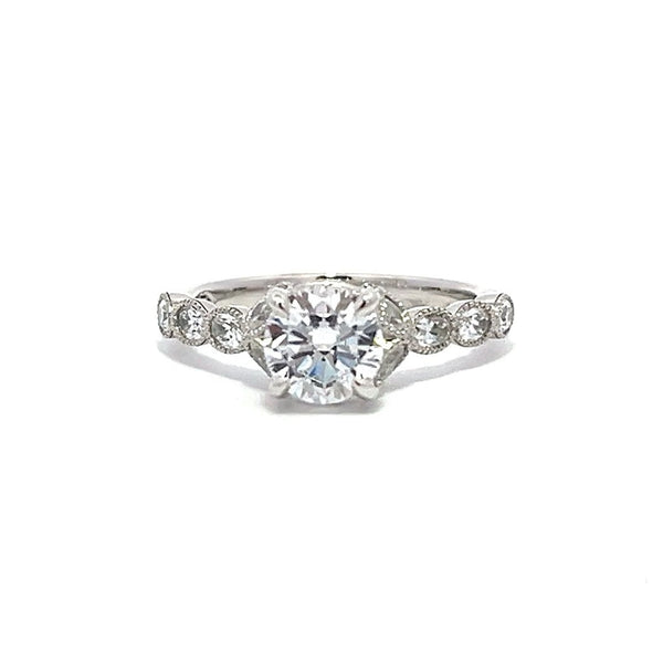 White gold diamond engagement ring with a diamond band on a white background