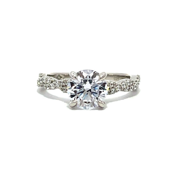 White gold diamond engagement ring with a twisted band on a white background.