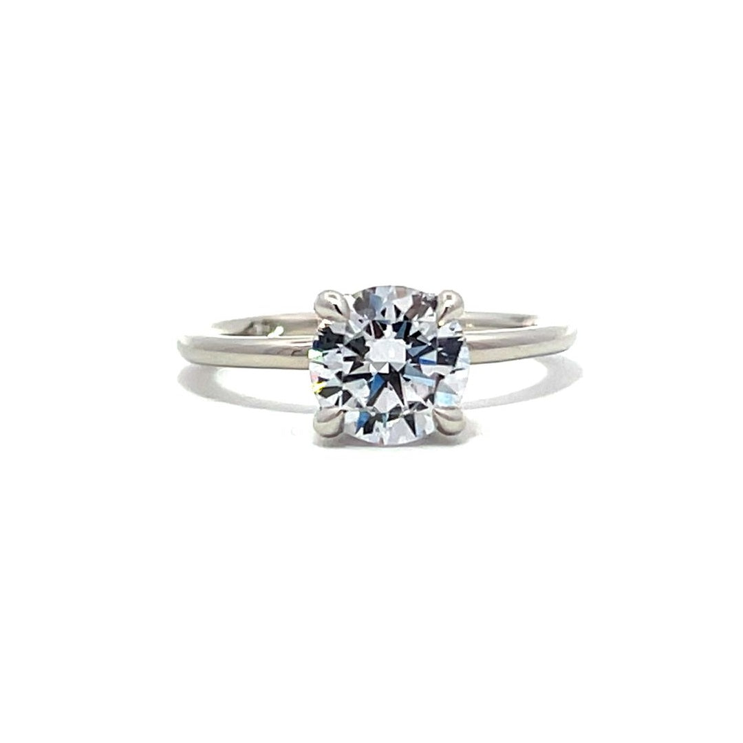 White gold diamond solitaire engagement ring on a white background.