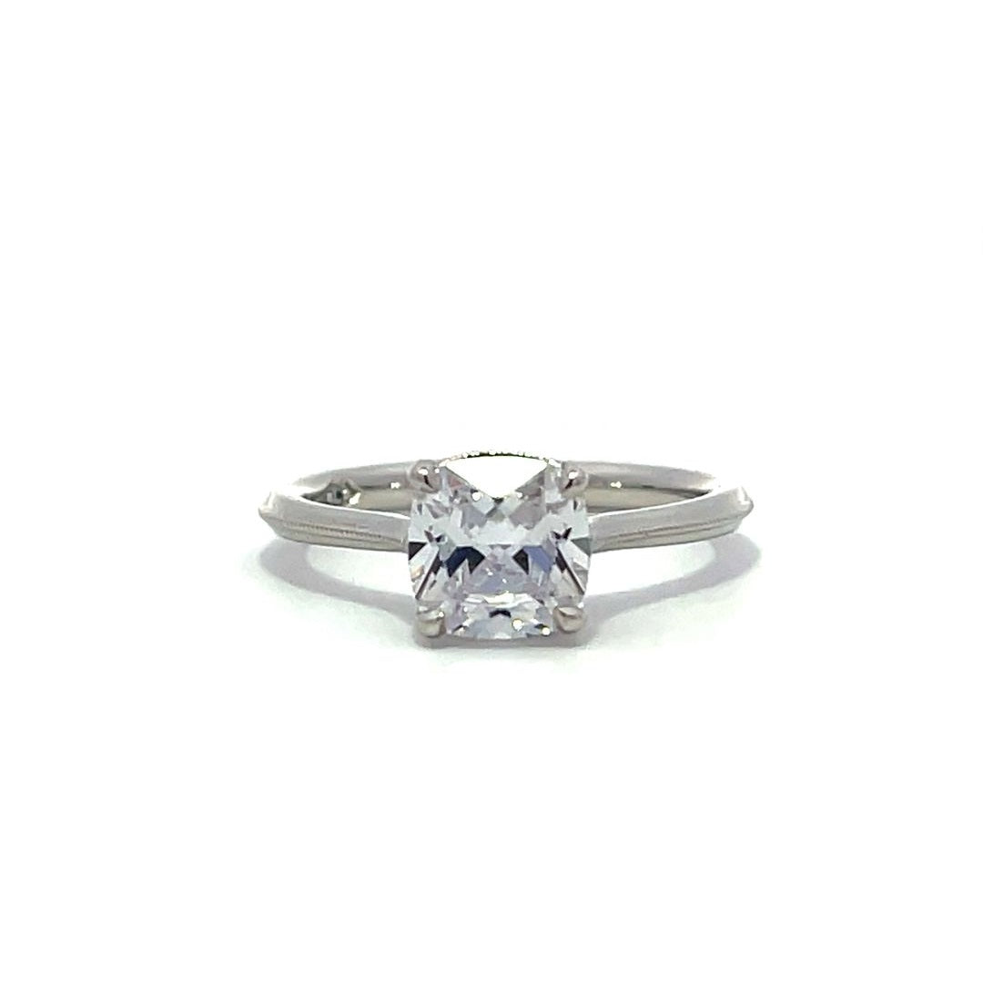 White gold cushion-cut diamond engagement ring on a white background