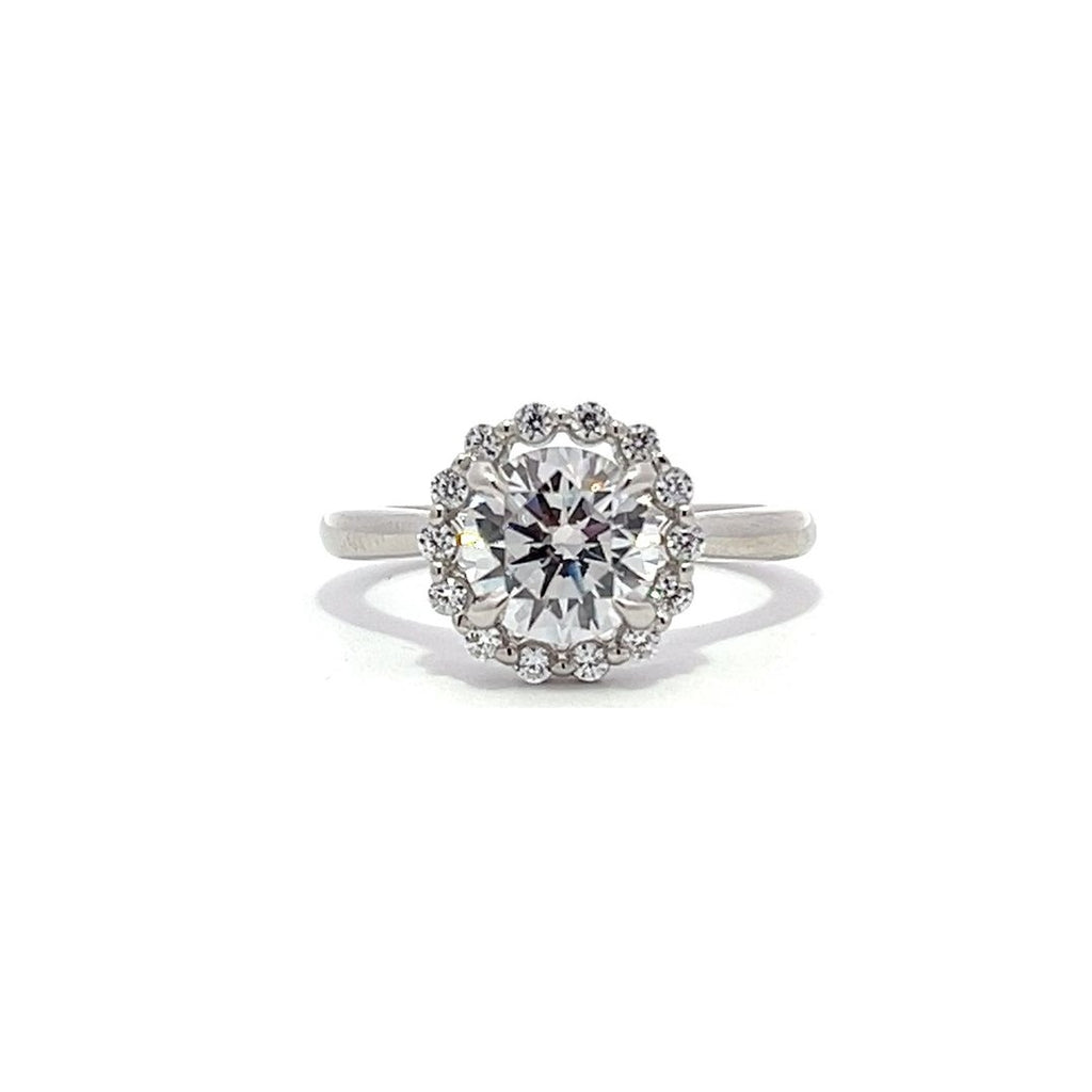 White gold diamond engagement ring with a halo setting on a white background.