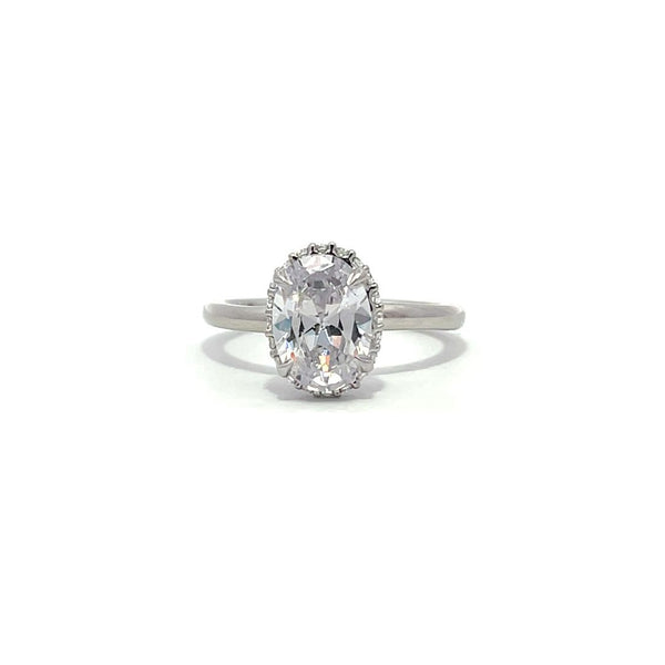 White gold oval diamond engagement ring with a halo setting on a white background